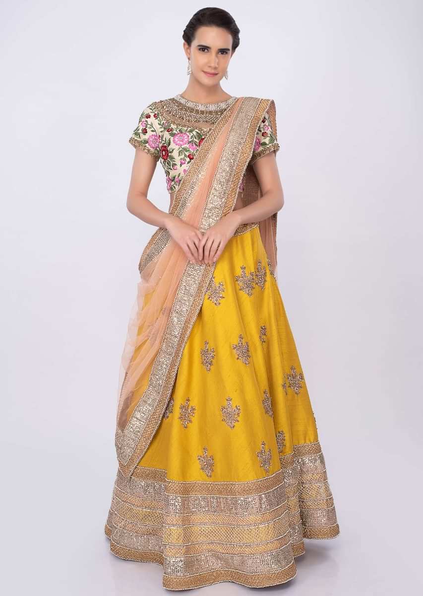 Chrome Yellow Lehenga In Raw Silk With Cream Blouse And Pale Pink Net Dupatta Online - Kalki Fashion