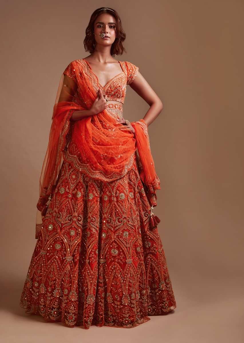 Coral Orange Lehenga Choli In Net With Mirror And Sequins Embroidered Floral And Mughal Embroidery Along With Belt Detailing 