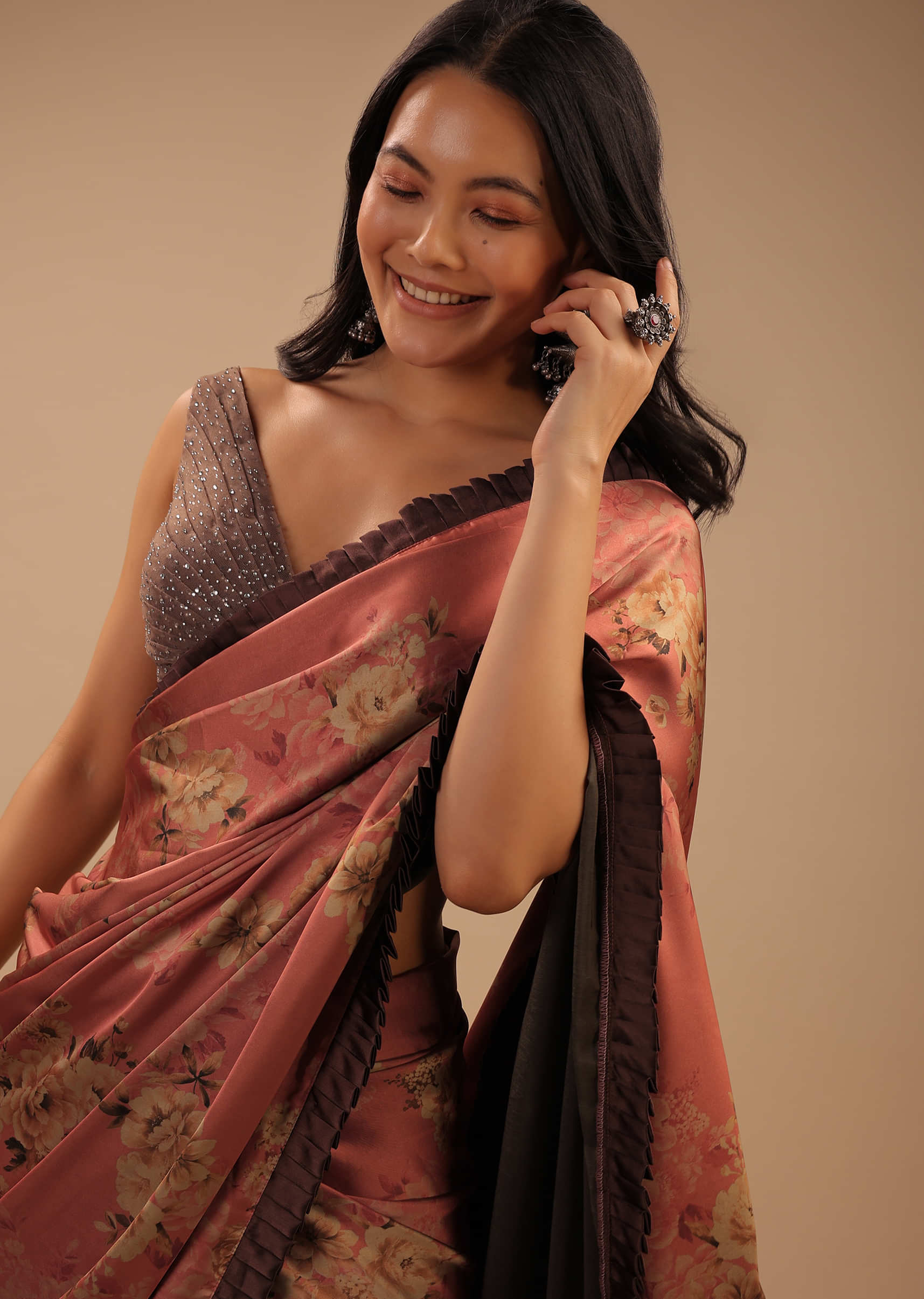 Coral Peach Saree With Brown Frill Borders And Floral Print