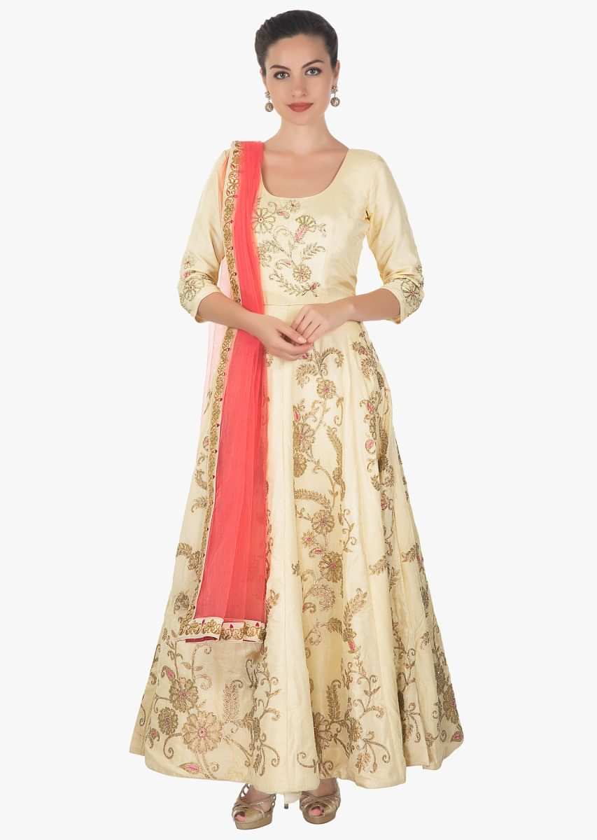 Cream anarkali in cotton silk paired with lycra chudidar and peach net dupatta only on kalki
