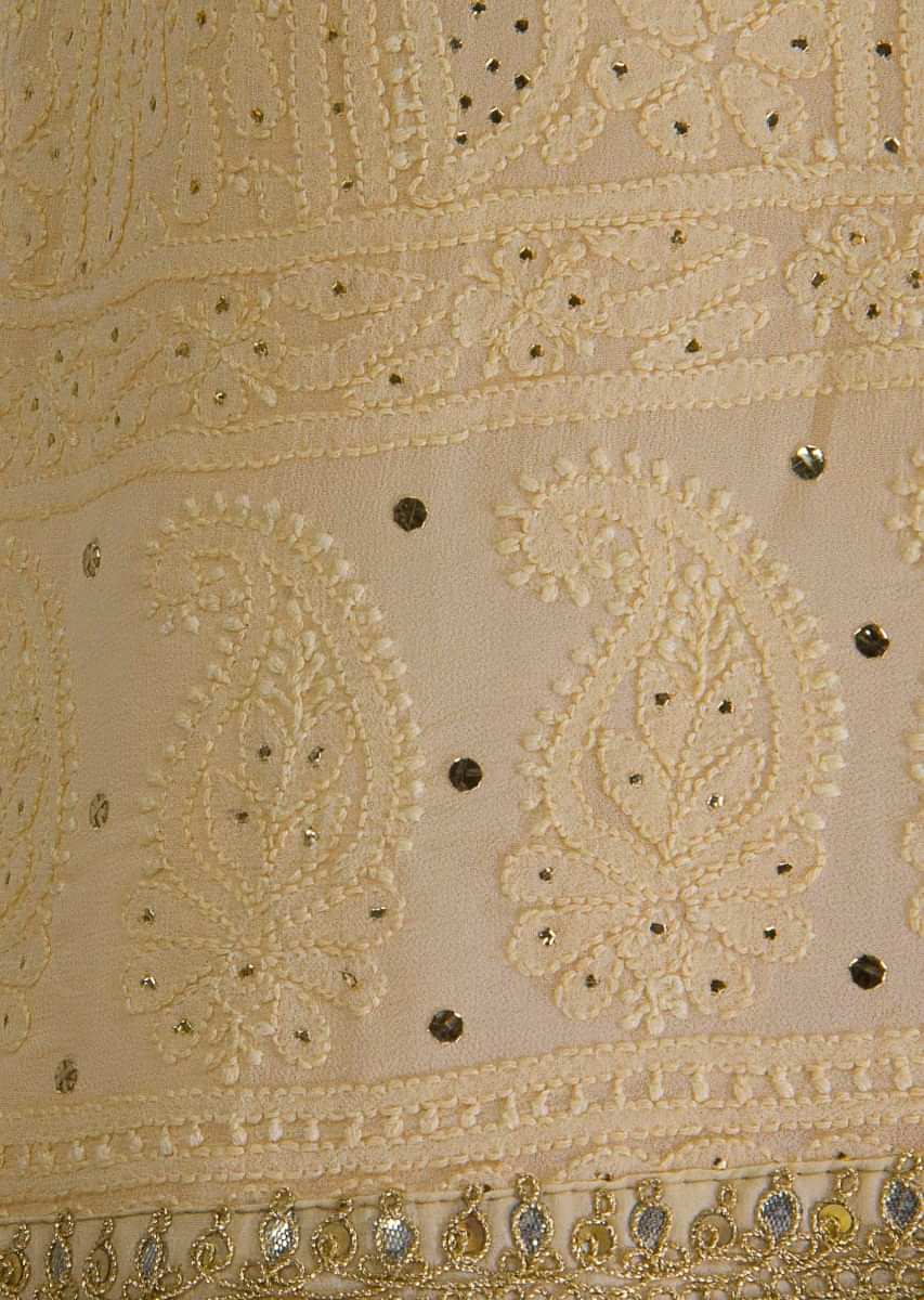 Cream unstitched lucknowi thread embroidered suit in alternate kali with paisley and floral motif