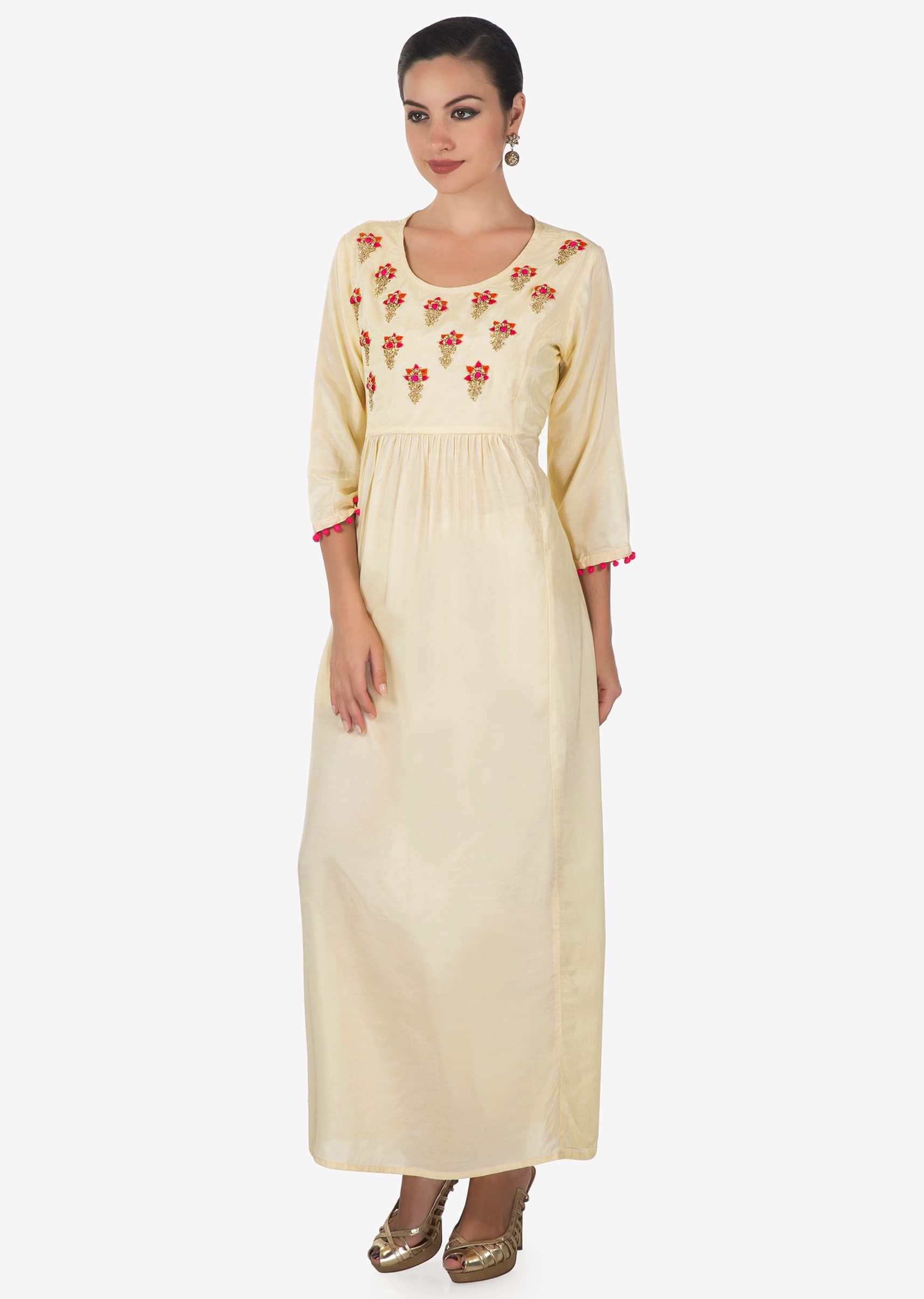 Cream dress adorn in embroidered butti and gathers only on Kalki