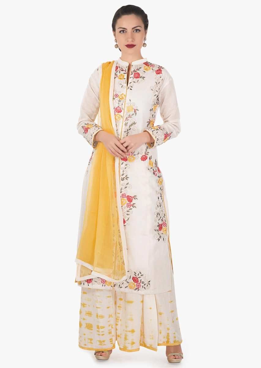 Cream and yellow semi stitched palazzo suit in silk with floral and zari embroidery only on Kalki