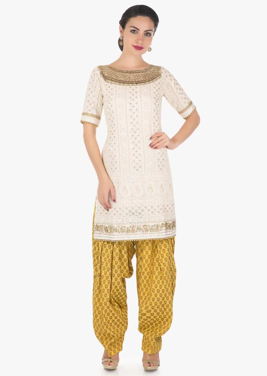 Cream straight suit in thread and sequin work with yellow salwar and net dupatta only on Kalki