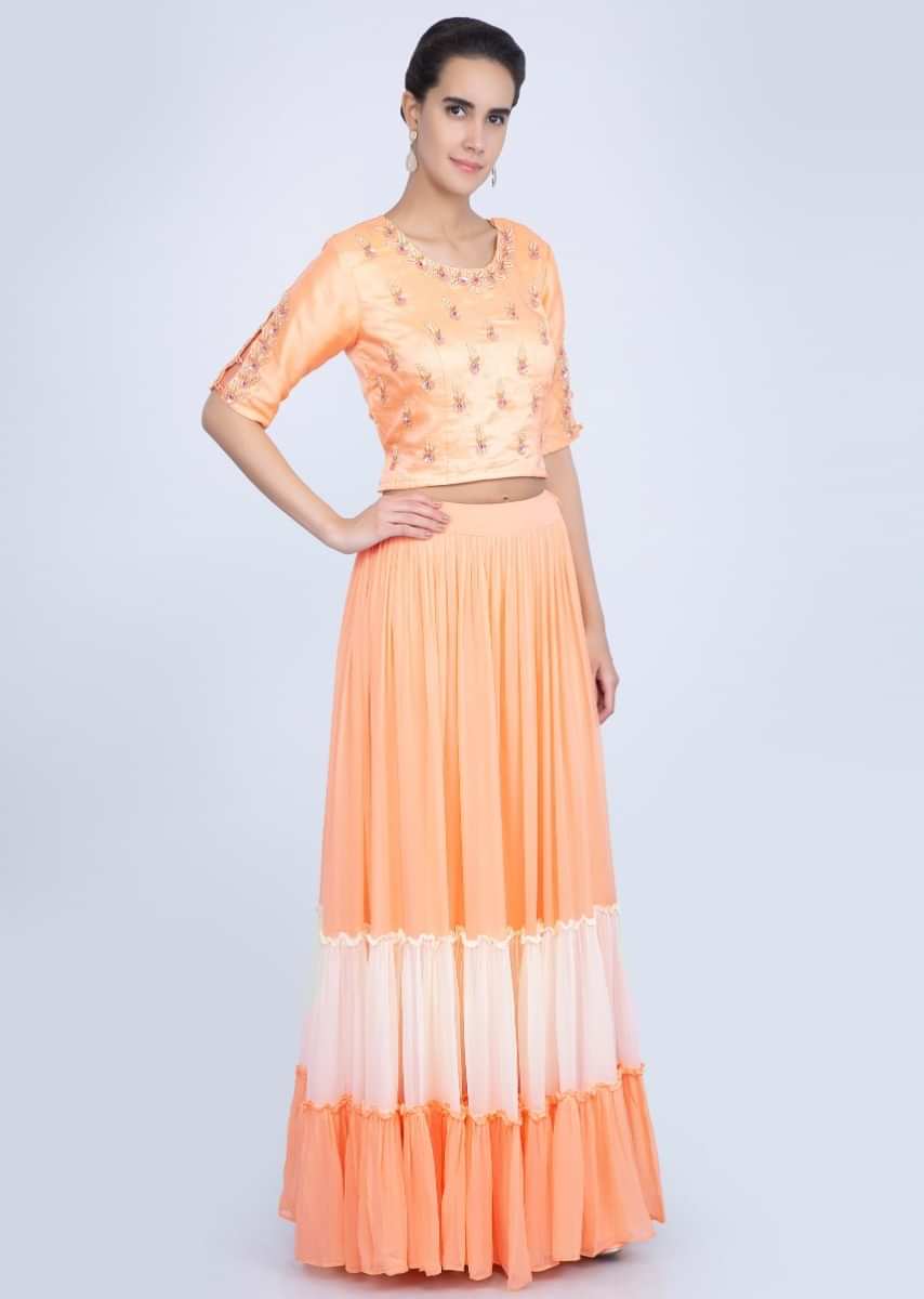 Creamish Peach Blouse With Embroidery Work Paired With Shaded Lehenga Online - Kalki Fashion