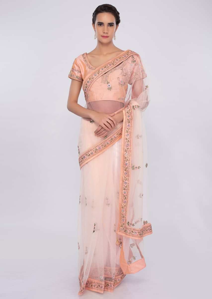 Creamish peach net saree with embroidered peach raw silk blouse only on kalki