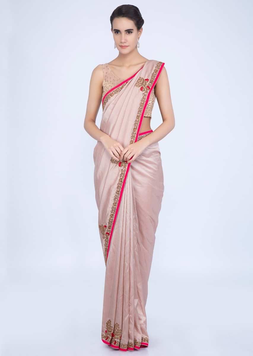 Creamish peach silk saree with contrasting red embroidered border only on Kalki