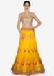 Amber yellow lehenga in floral motif with contrast rani pink dupatta in brocade only on Kalki