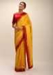 Amber Yellow Saree In Silk With Lurex Woven Chevron Design And Red Bandhani Border Along With Unstitched Blouse  