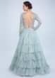 Aqua Blue Gown With Frilled Layer In Embroidered Net And Sheer Net Deep V Bodice