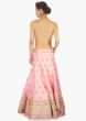 Baby pink raw silk lehenga set  paired with a contrasting green net dupatta