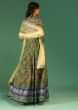 Bottle Green Anarkali Suit In Raw Silk With Patola Print And Kundan Detailing Along With A Yellow Net Dupatta  