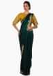 Bottle green saree in satin with mustard blouse beautified in zardosi and gotta patch work only on Kalki