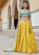 Bright yellow lehenga in silk with contrast blouse adorn in zari and resham work only on Kalki