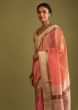 Carrot Coral Saree In Tussar Silk With A Contrasting Woven Golden Border And Textured Tussar Detailing On The Pallu  