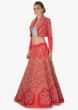 Coral lehenga paired with mint green strapless blouse and coral jacket