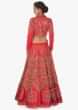 Coral lehenga paired with mint green strapless blouse and coral jacket