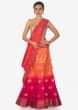 Coral and pink shaded lehenga in silk enhanced in weave embroidery only on Kalki