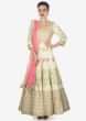 Cream cotton silk anarkali suit paired with pink net dupatta and lycra chudidar only on kalki