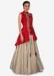 Cream lehenga matched with red jacket blouse adorn in french knot embroidery only on Kalki