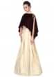 Cream lehenga matched with maroon cape only on Kalki