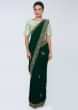 Emerald green satin saree embellished with cut dana embroidered butti and border