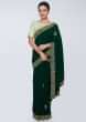 Emerald green satin saree embellished with cut dana embroidered butti and border