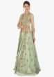 Fern green cotton silk lehenga  paired with a matching blouse and an additional net jacket