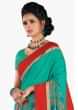 Fern green saree in floral print with red contrast border 