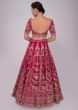 Fuchsia pink raw silk lehenga set in floral and temple embroidery 