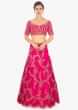 Fuschia pink raw silk lehenga and blouse paired with matching net dupatta 