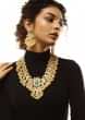 Gold Plated Kundan Necklace And Earrings Set With Green Carved Stone Pendant And Edged With Yellow And White Pearls 