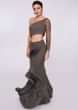 Graphite grey skirt in bias ruffle cut panel paired with one shoulder embroidered top