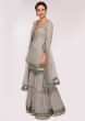 Grey embroidered georgette suit paired with  flared sharara and net dupatta only on Kalki 