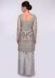 Grey net suit in embroidered jaal work paired with raw silk palazzo with net top layer 