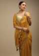 Honey Yellow Saree In Organza With Bandhani Buttis And Gotta Patti Embroidered Floral Motifs On The Border  