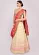 Light cream cotton silk weaved lehenga paired with fushia pink weaved dupatta
