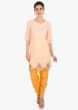Light peach top paired with a yellow dhoti pant 