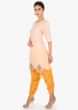 Light peach top paired with a yellow dhoti pant 