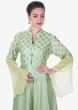 Light pista green suit featuring with foil printed butti and fancy buttons only on Kalki