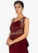 Maroon  one side strap gown in peplum style embellished in bird and floral motif