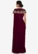 Maroon saree gown in net with a fancy cape adorn in zardosi and moti embroidered work only on Kalki