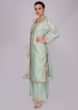 Mint green floral embroidered palazzo suit set with pink net dupatta.