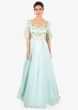 Mint green gown designed with over lapping sleeves and layers 