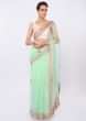 Mint green organza saree in floral embroidery and butti only on kalki