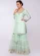 Mint green suit in embroidery and butti paired with net sharara