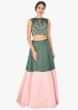 Moss green and pink satin lehenga with a matching crop top and pink net dupatta 