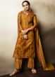 Mustard brown unstitched suit in cotton with floral butti and printed neckline