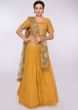Mustard net embroidered lehenga and blouse with contrasting green net dupatta
