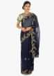 Navy blue organza saree  paired with a contrasting Pista green raw silk blouse